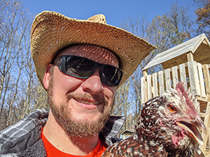 Eric Ianni holding a chicken.