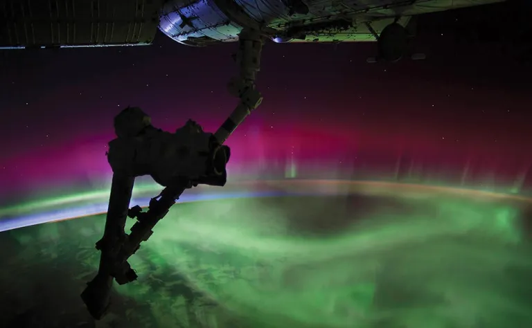Intense greens, reds, and blues lights from an aurora.