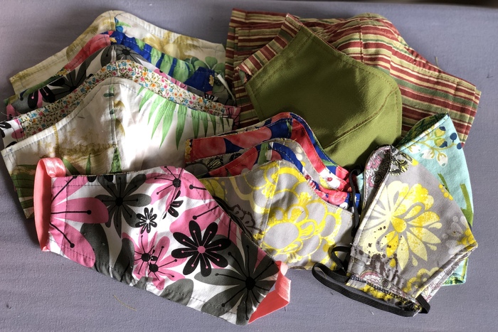 Multicolored, patterned sewn cloth masks.