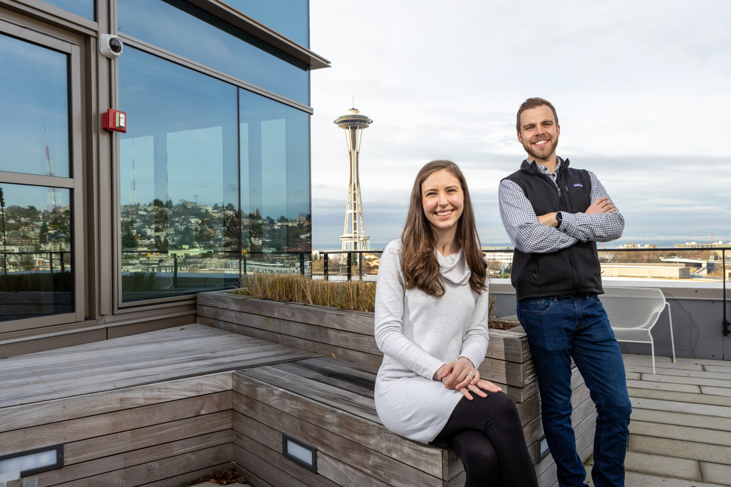 Brynn Olden and Anthony Amsberry pose with the Space Needle in the background.
