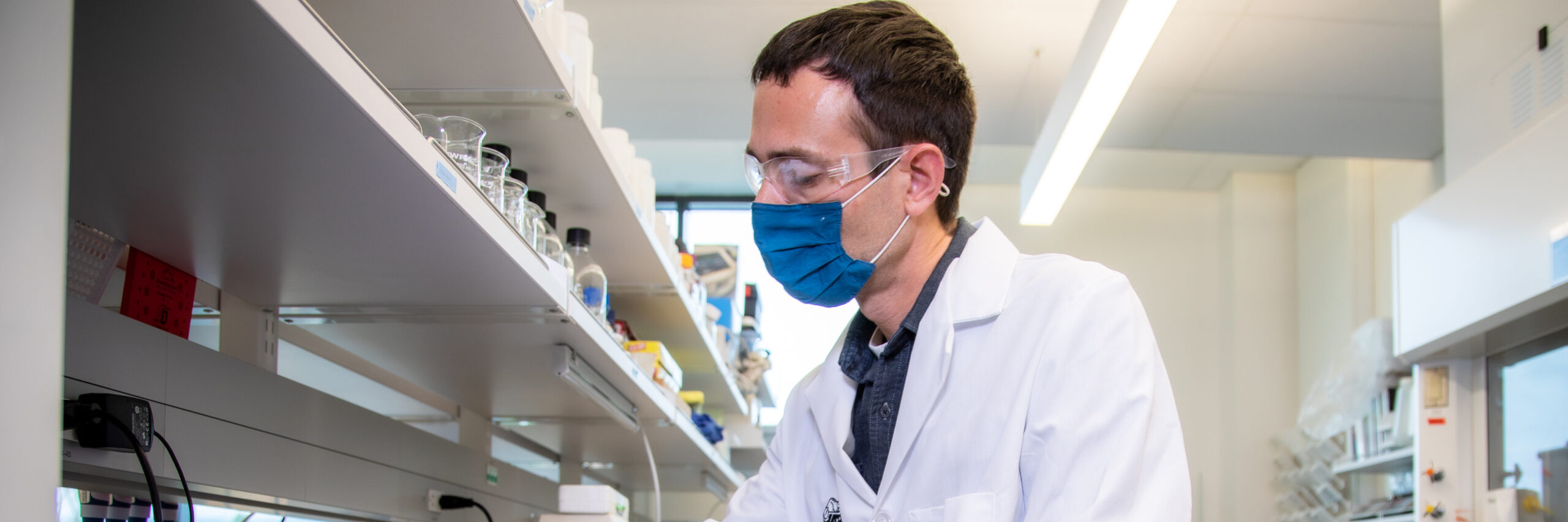 Adam Higgins wearing PPE in lab.