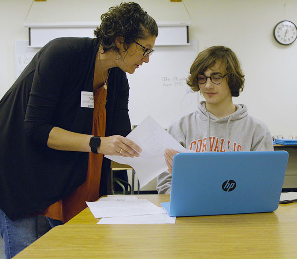Jennifer Parham-Mocello (left), assistant professor of computer science, works with a high school student.