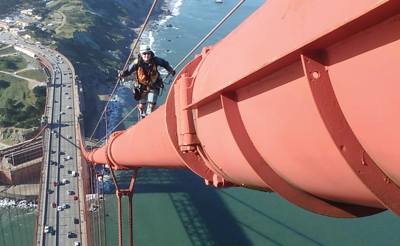 Nick Clark walking on railing of a bridge. 