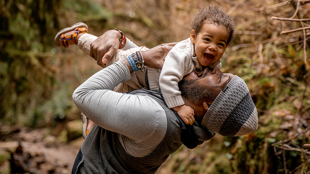 Blessed Ndlovu playfully holding his son in the air.