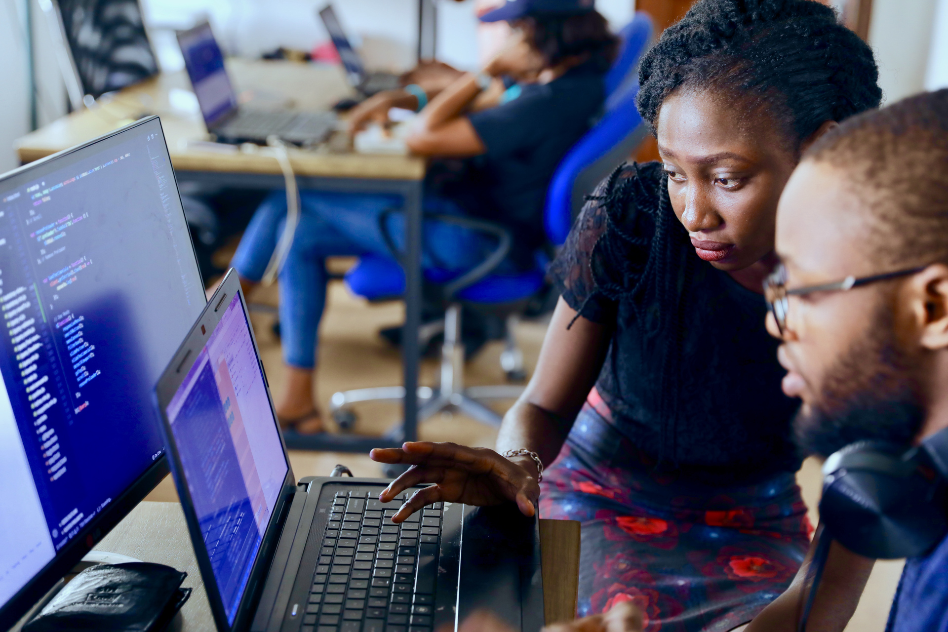 Two people looking at a computer screen.