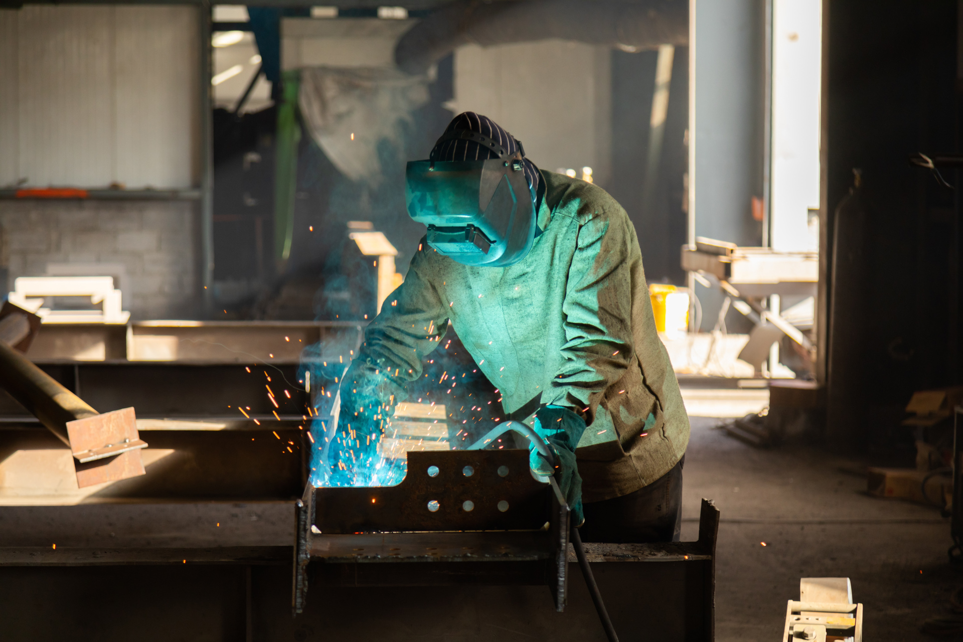 A person wearing protective gear while welding. 