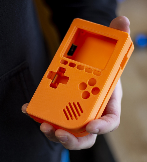 Orange 3D-printed game console casing.