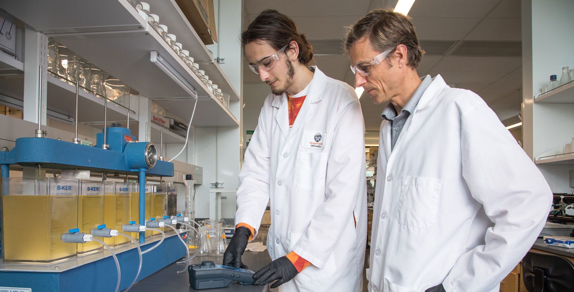 Jeff Nason and student in lab uniform