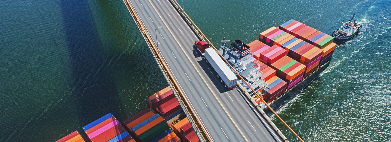 Semi-truck transporting over a bridge