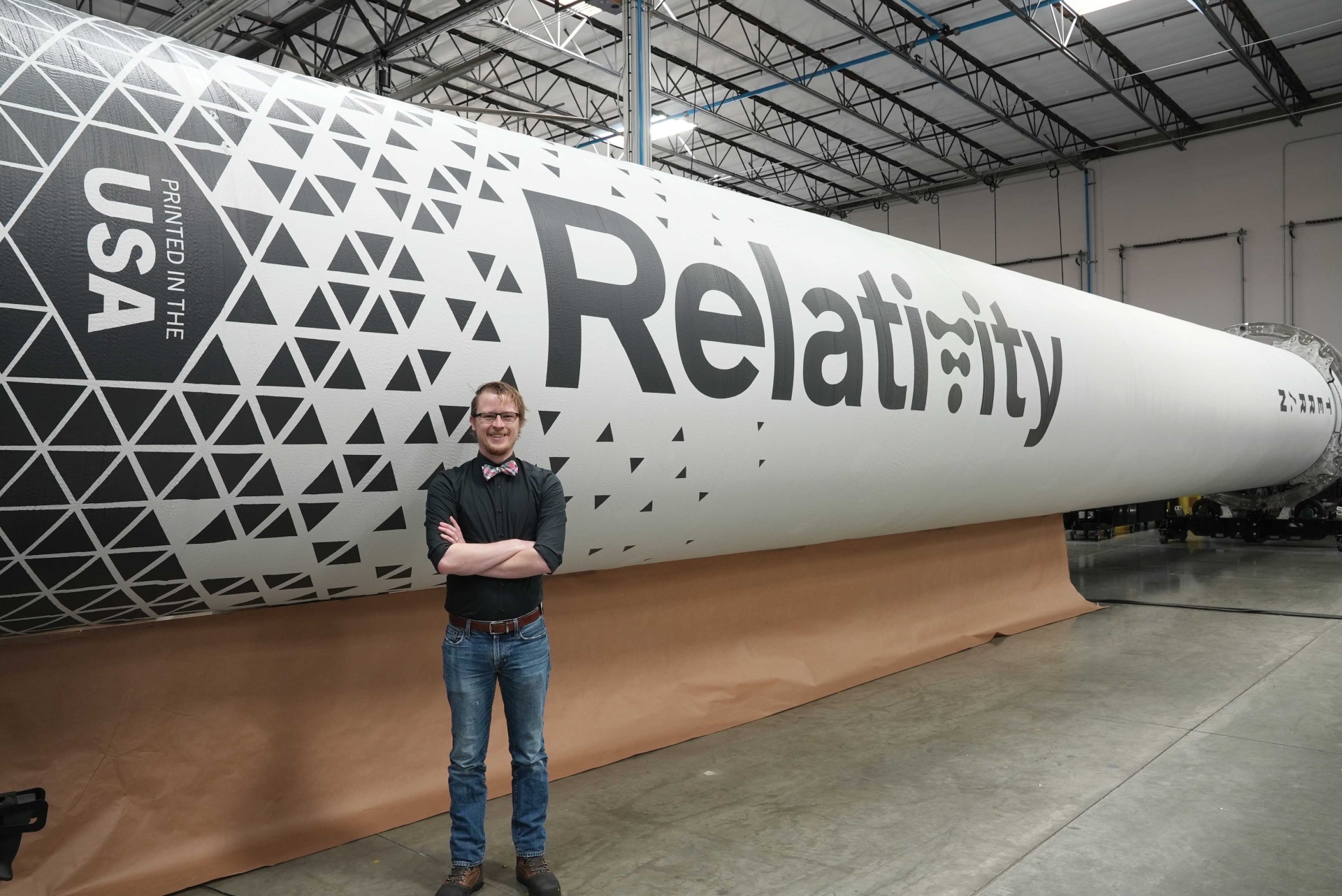 A.J. Fillo standing in front of a rocket 
