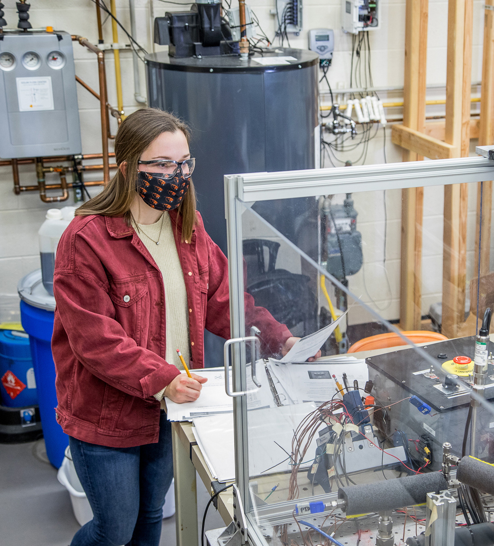 Aerospaceundergradute student Kristen Travers wearing a mask while working in an aerospace laboratory.