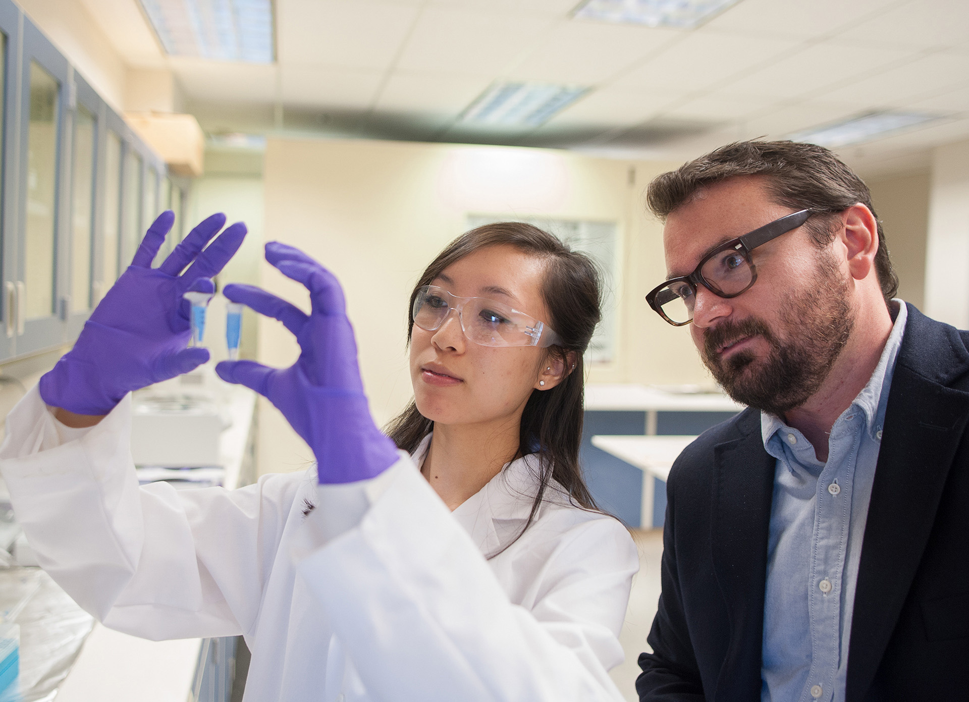 Bioengineering professor Joe Baio and a student examining some lab samples.