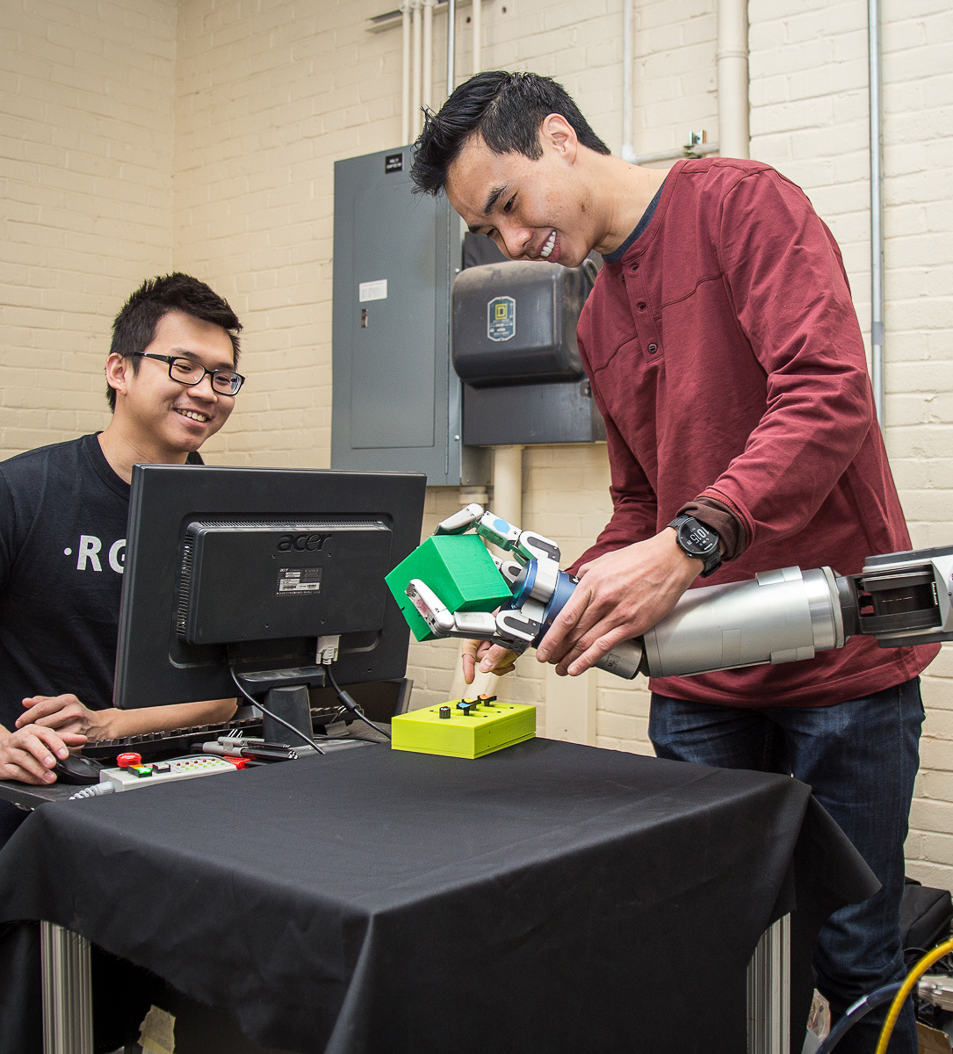 Bioengineering graduate student Anthony Lee conducting experiments on a robotic arm.