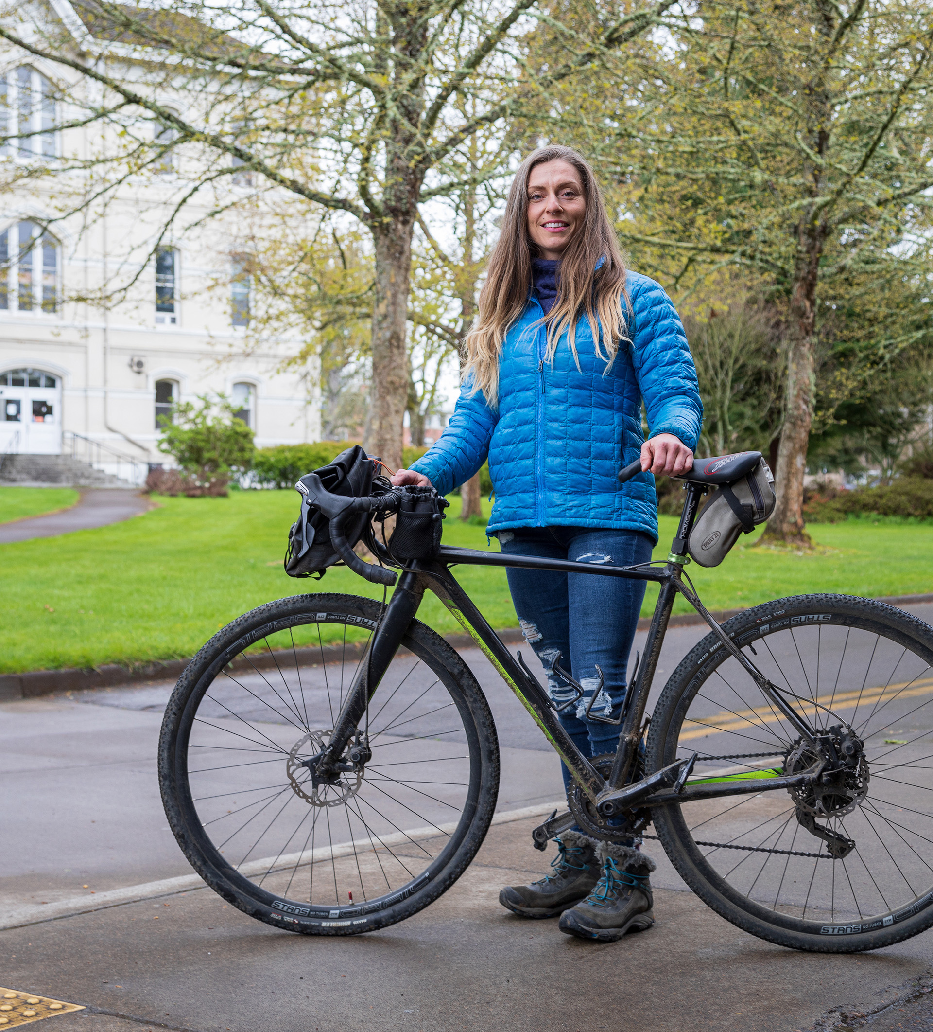 Construction engineering management alumni Tausha Smith posing with her bicycle.