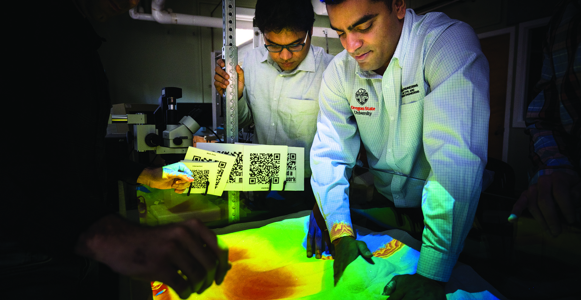 Construction engineering management professor Joseph Louis working on a landscape topography model with a student.