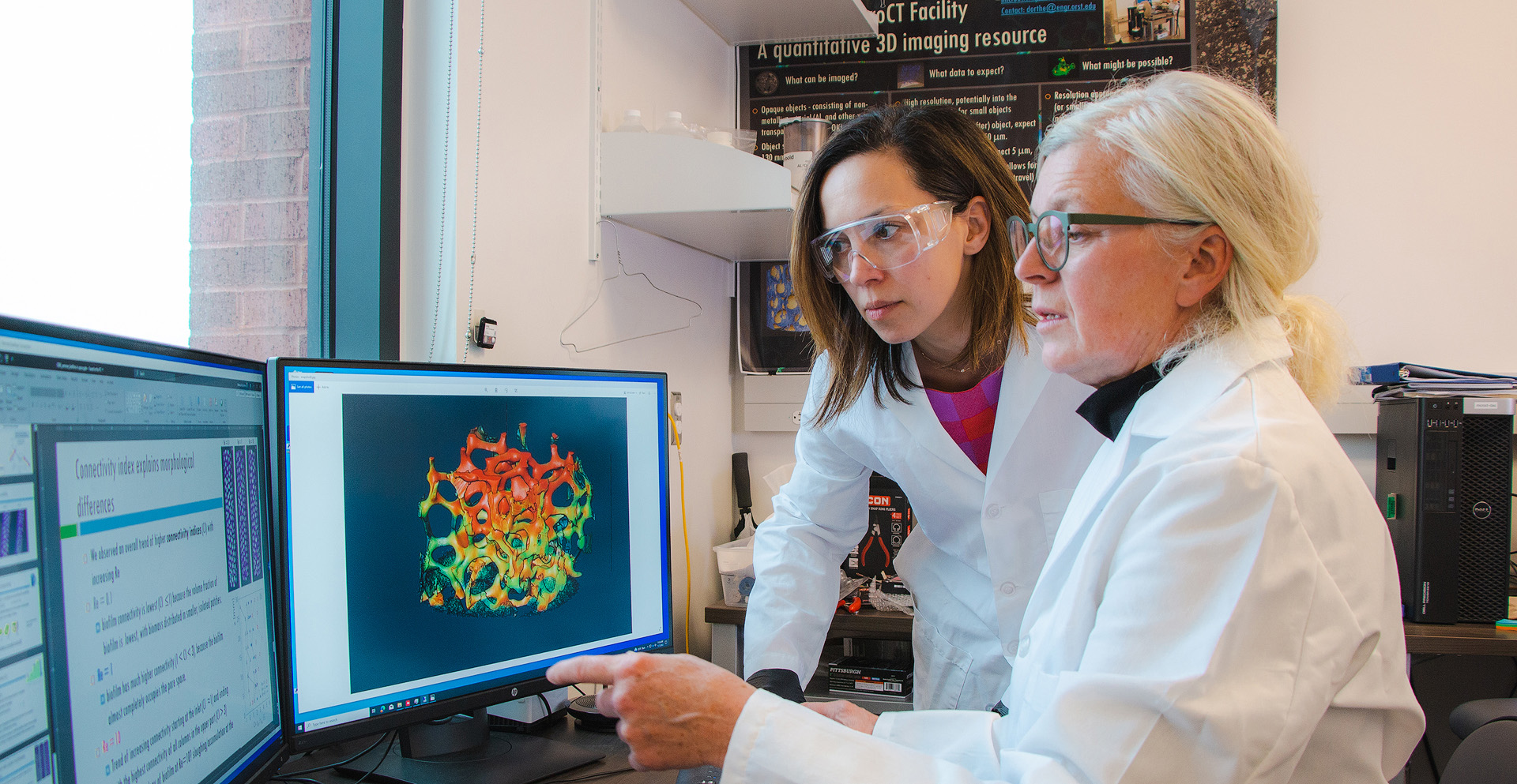 Dorthe Wildenschild and Tala Navab-Daneshmand, professors of environmental engineering, analyzing data visualizations on a computer.