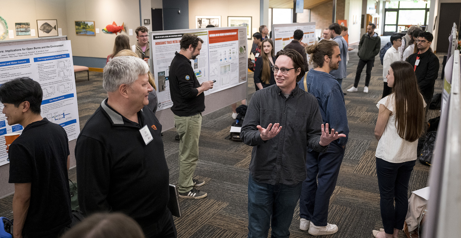 Environmental engineering students presenting their research at a university fair.