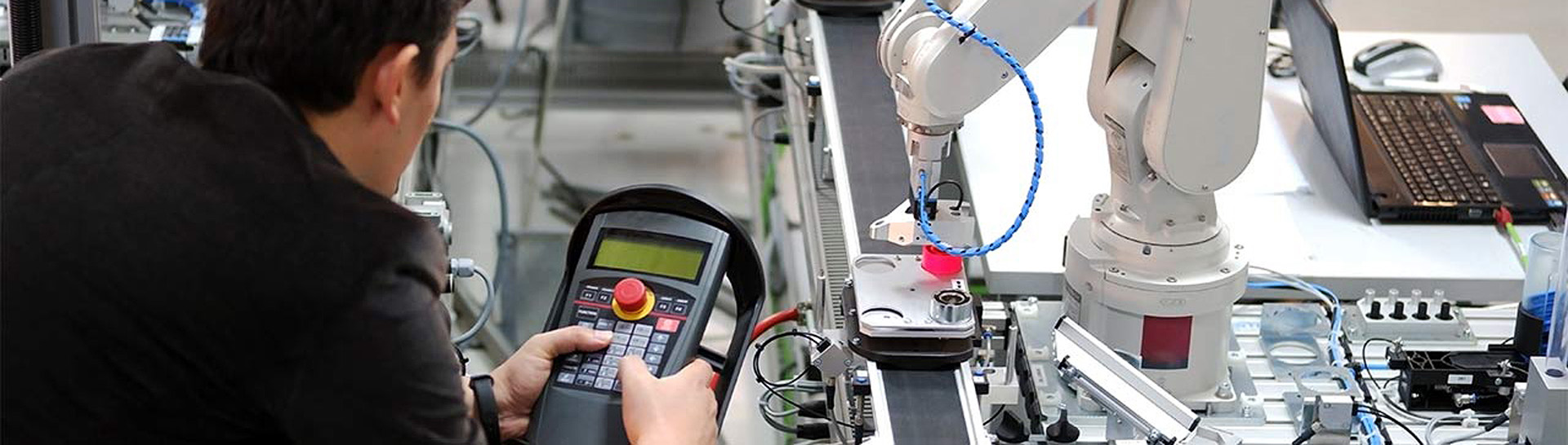 A mechatronics student working with machinery in the laboratory.