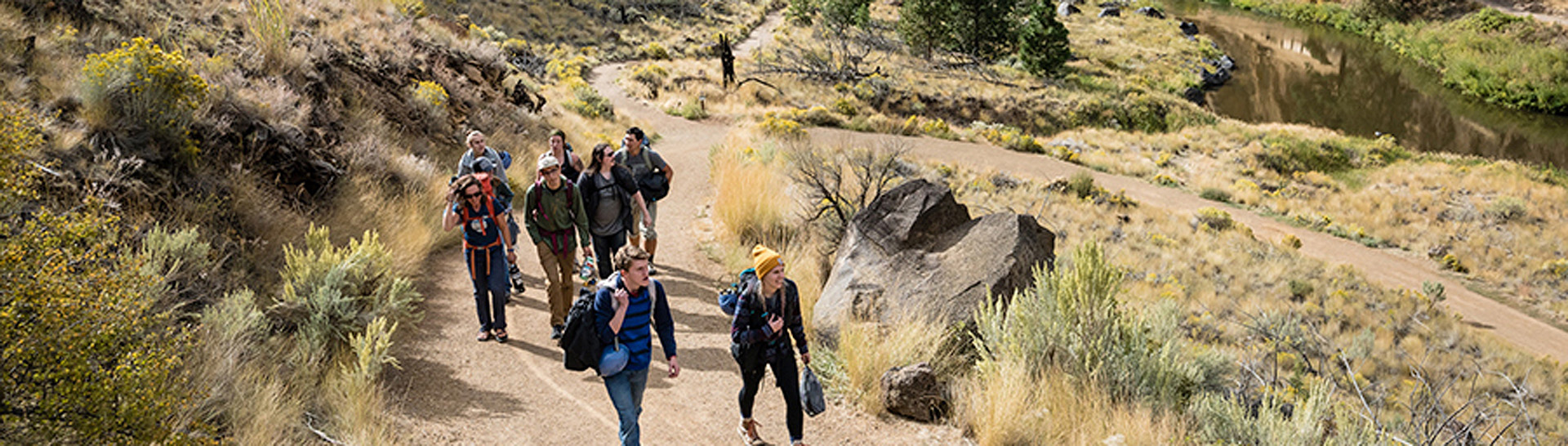 Aerial shot of a group of people walking up a trail.