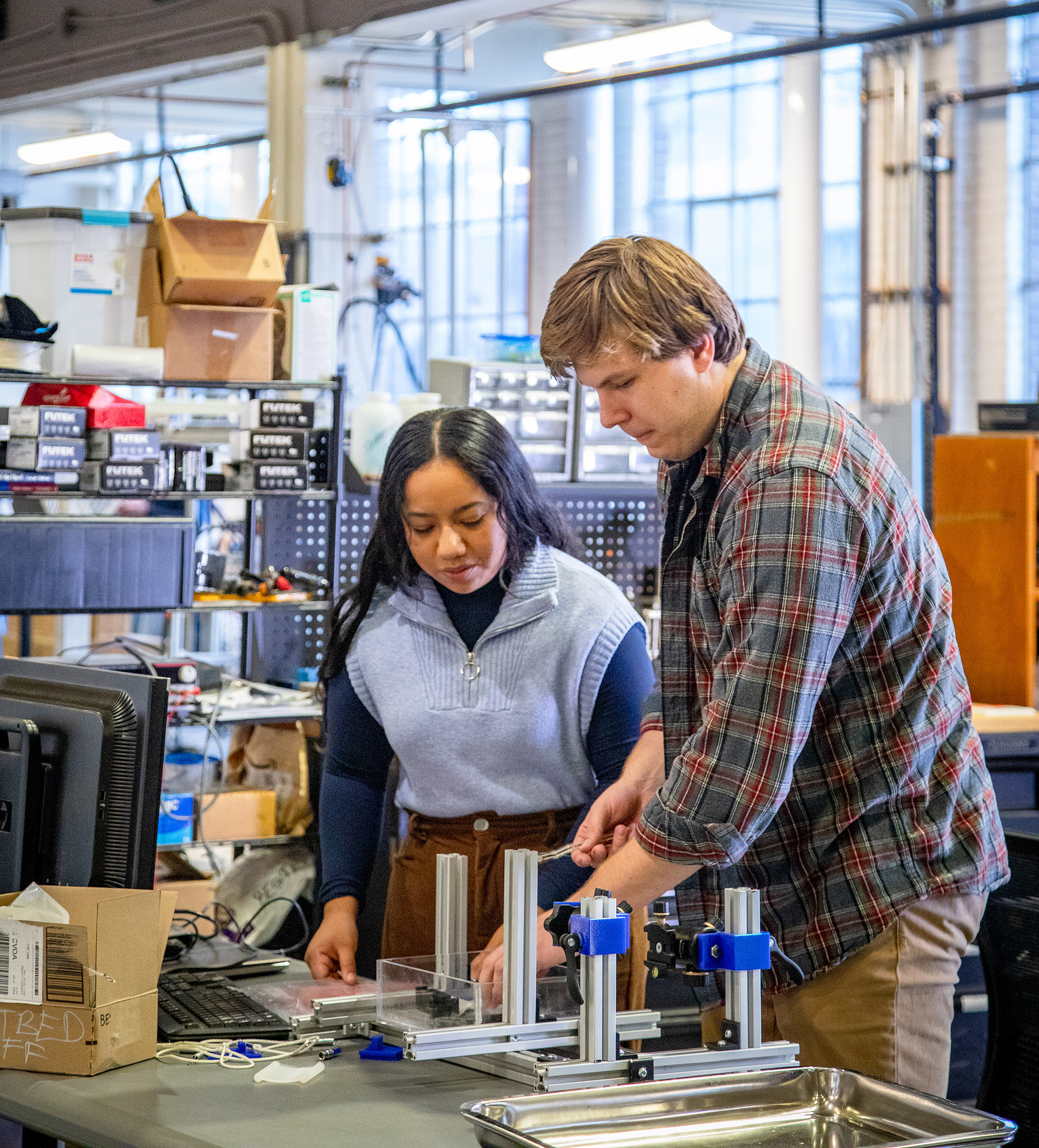 Electrical and computer engineering student Lesly Rojas working in a robotics lab with a colleague.