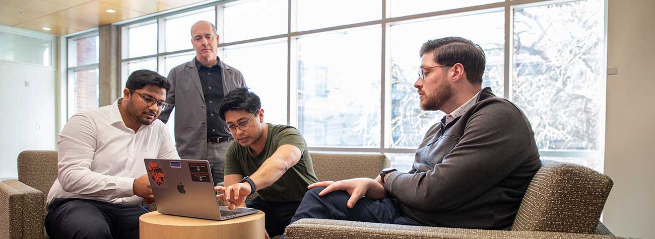 AI researchers discussing a project in Kelley Engineering Center.