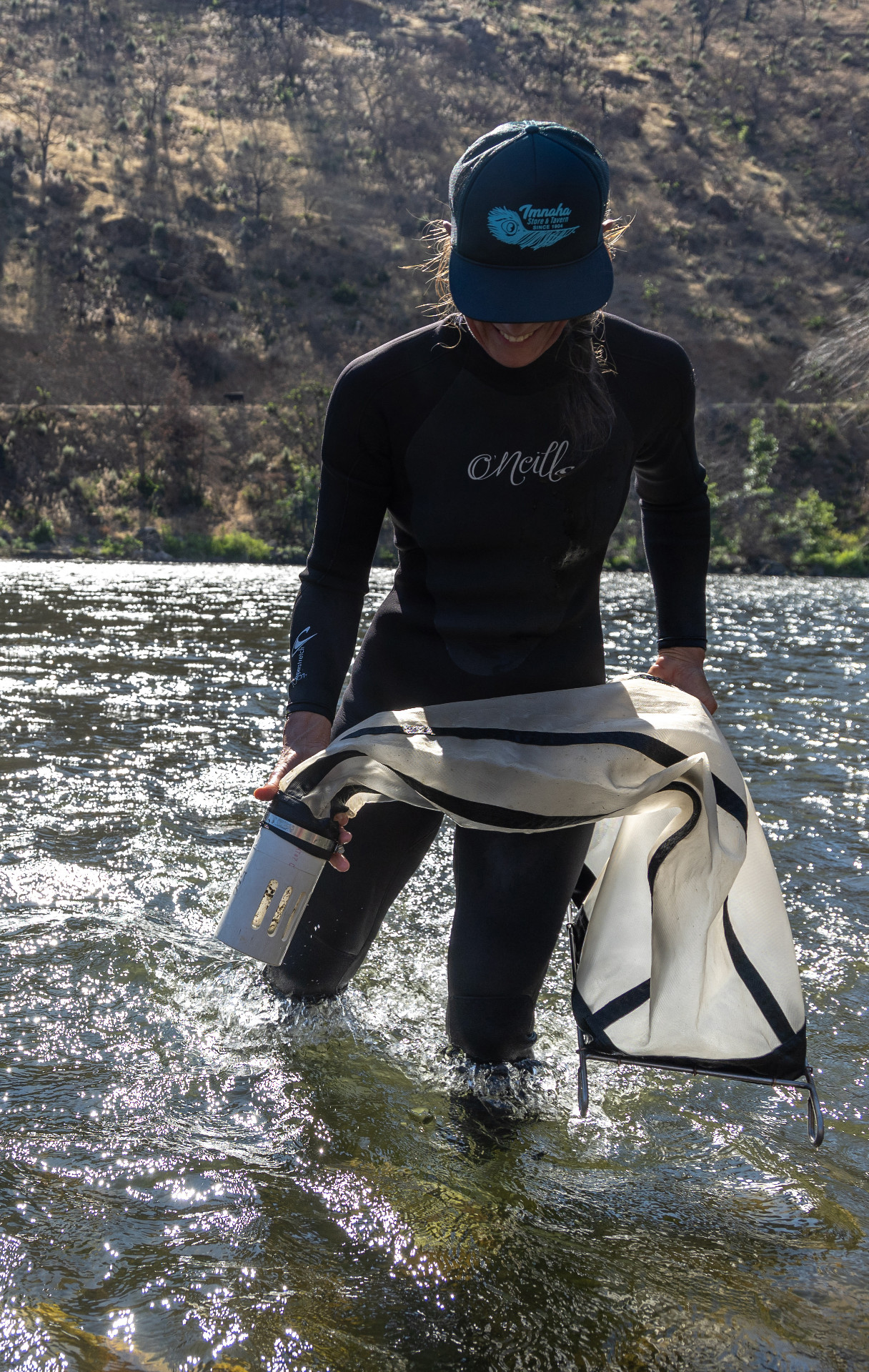 Biological and Ecological engineering alumni Desiree Tullos conducting research in the middle of the Klamath river.