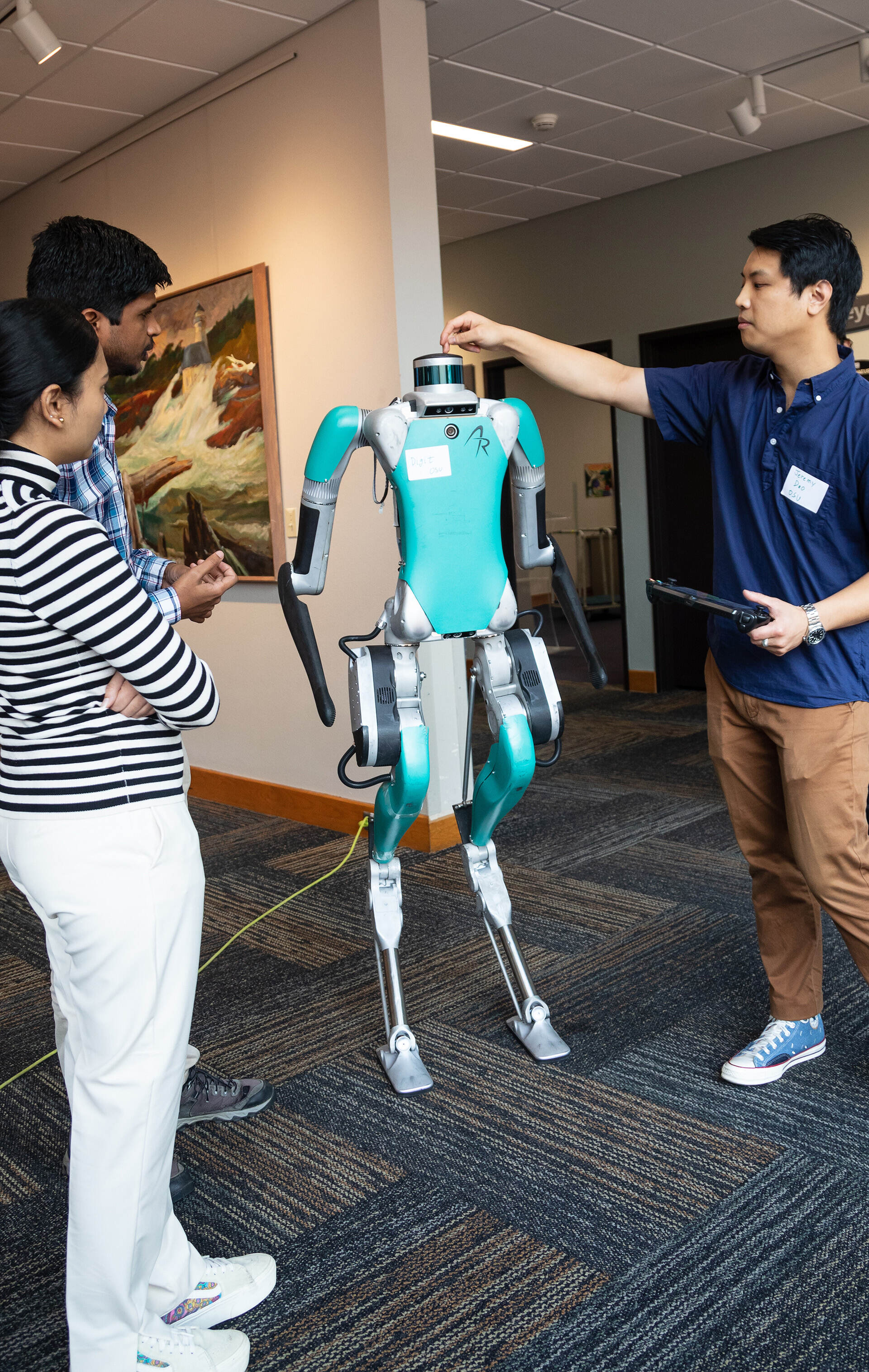 Robotics students testing their bipedal, humanoid robot.