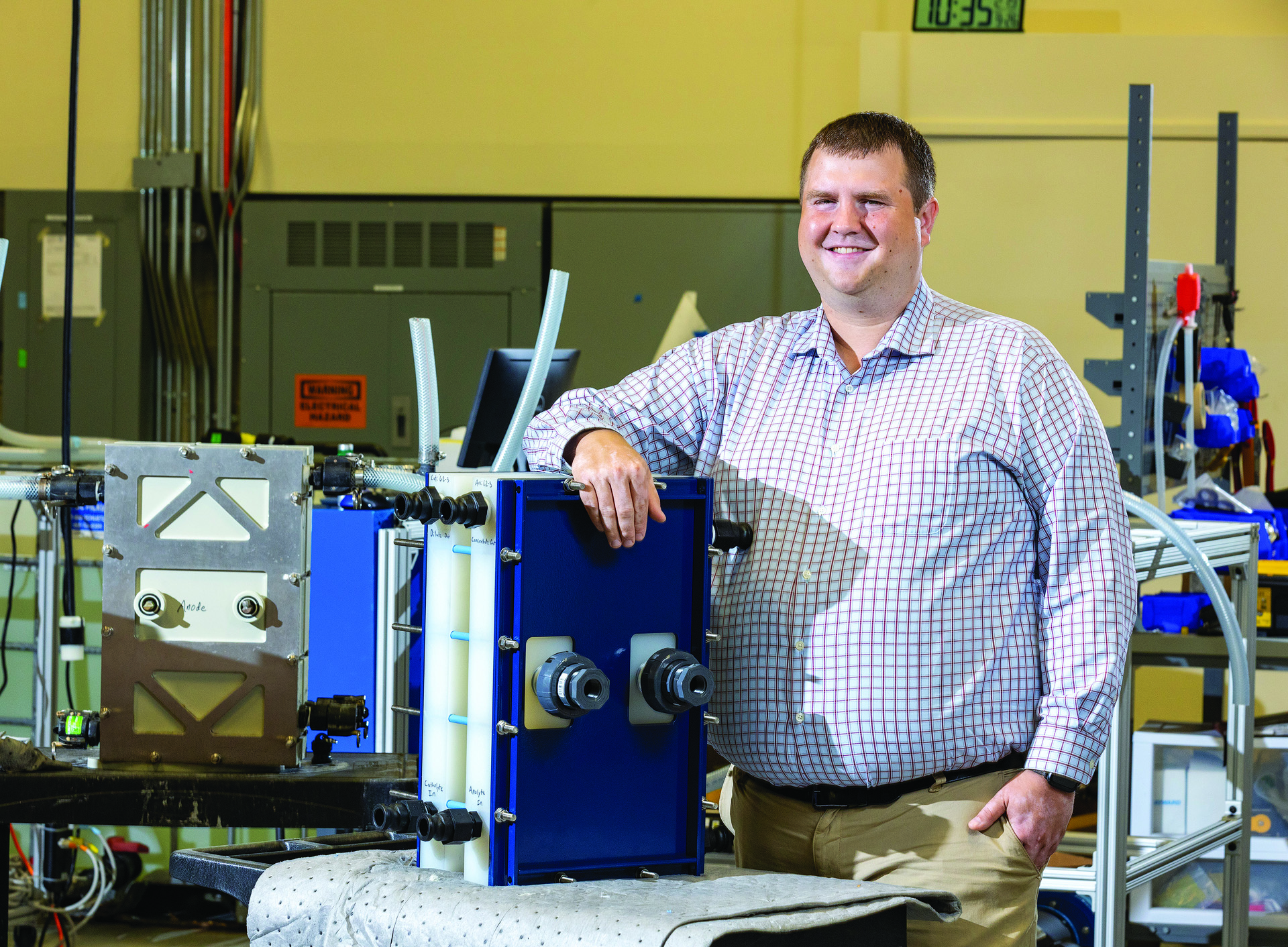 Chemical engineering alumni Greg Newbloom posing for photo with an unspecified piece of lab equipment.
