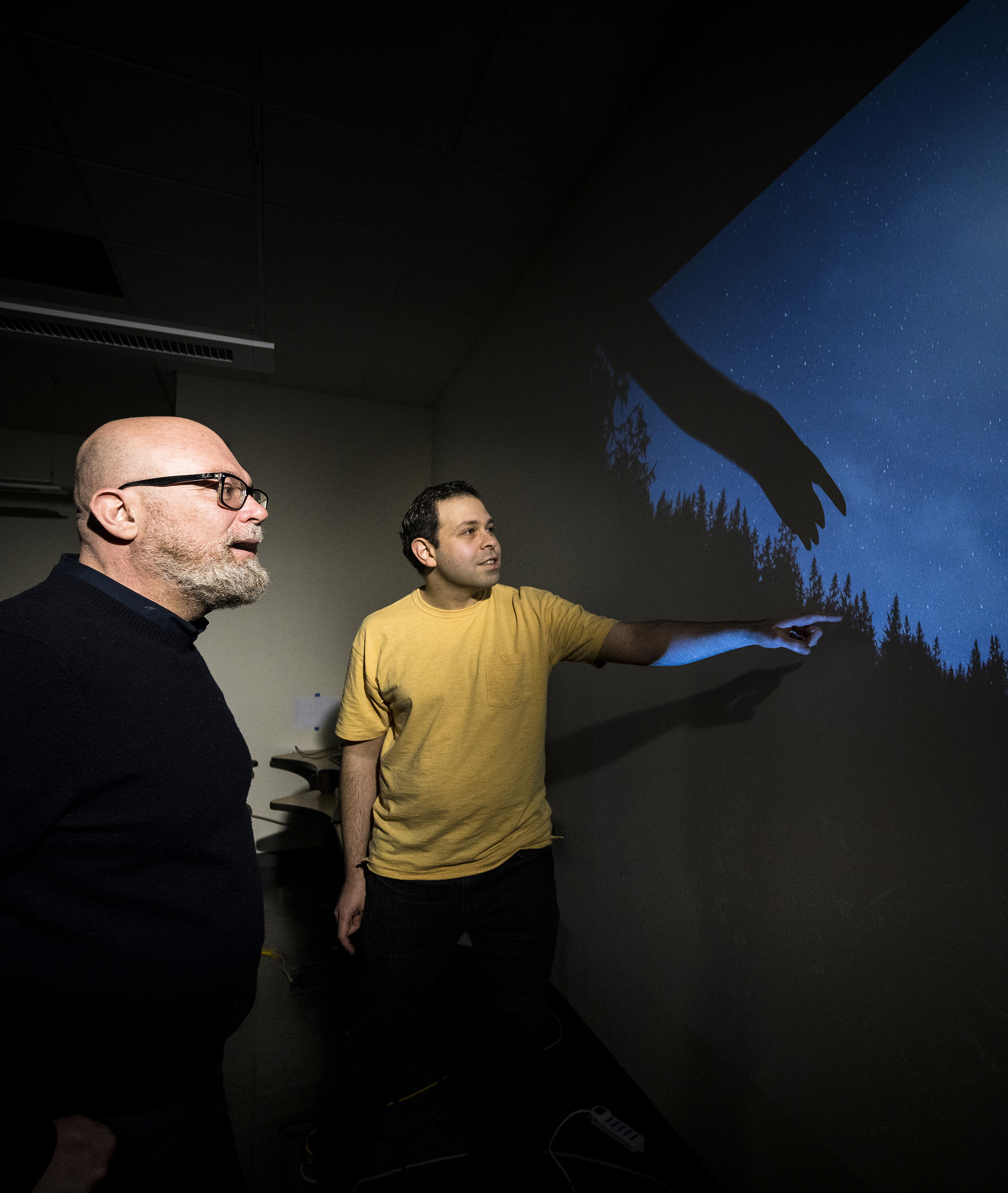 Two faculty members looking at a diagram in the Materials Synthesis and Characterization Facility