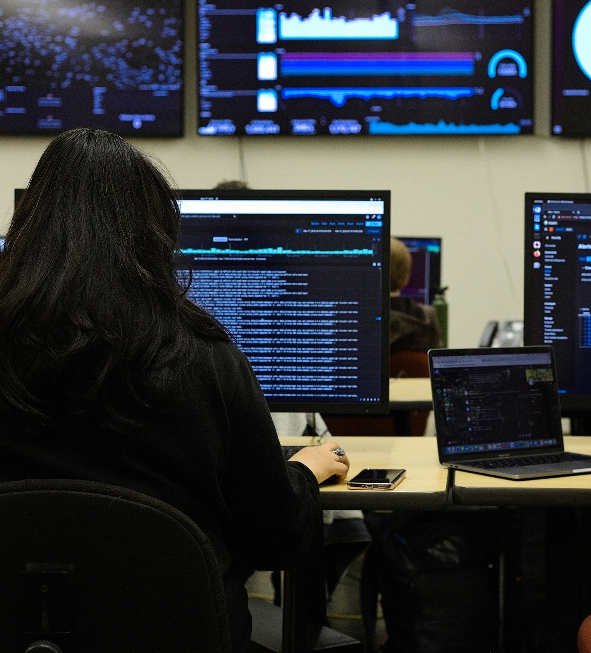 Student looking at lines of code on a desktop computer.
