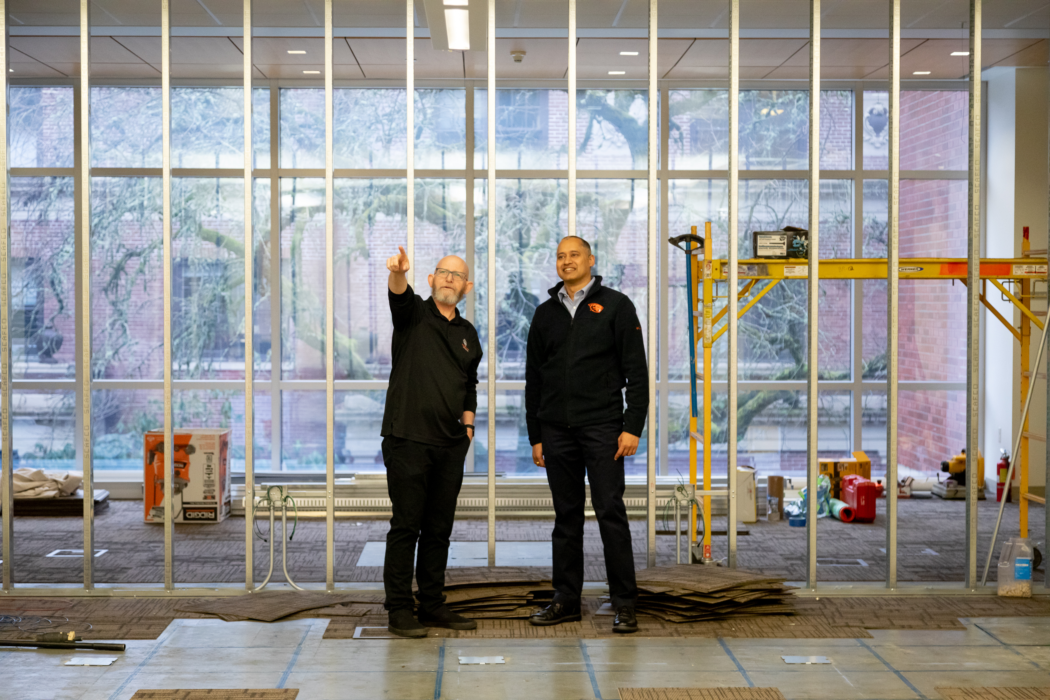 Oregon State staff members overseeing indoor building remodeling.