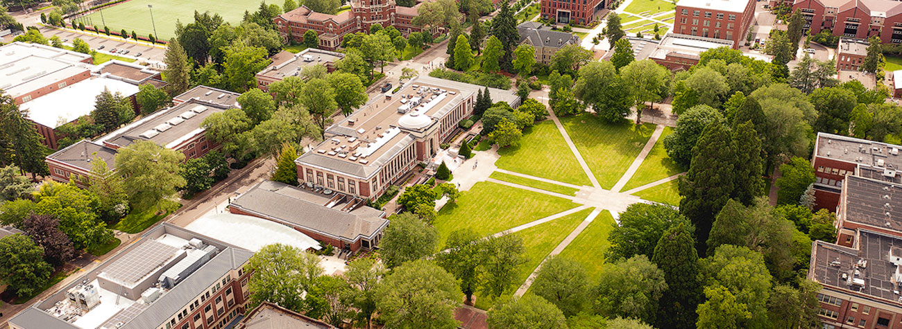Oregon State University campus seen from above with green vegetation, buildings, and walking paths.