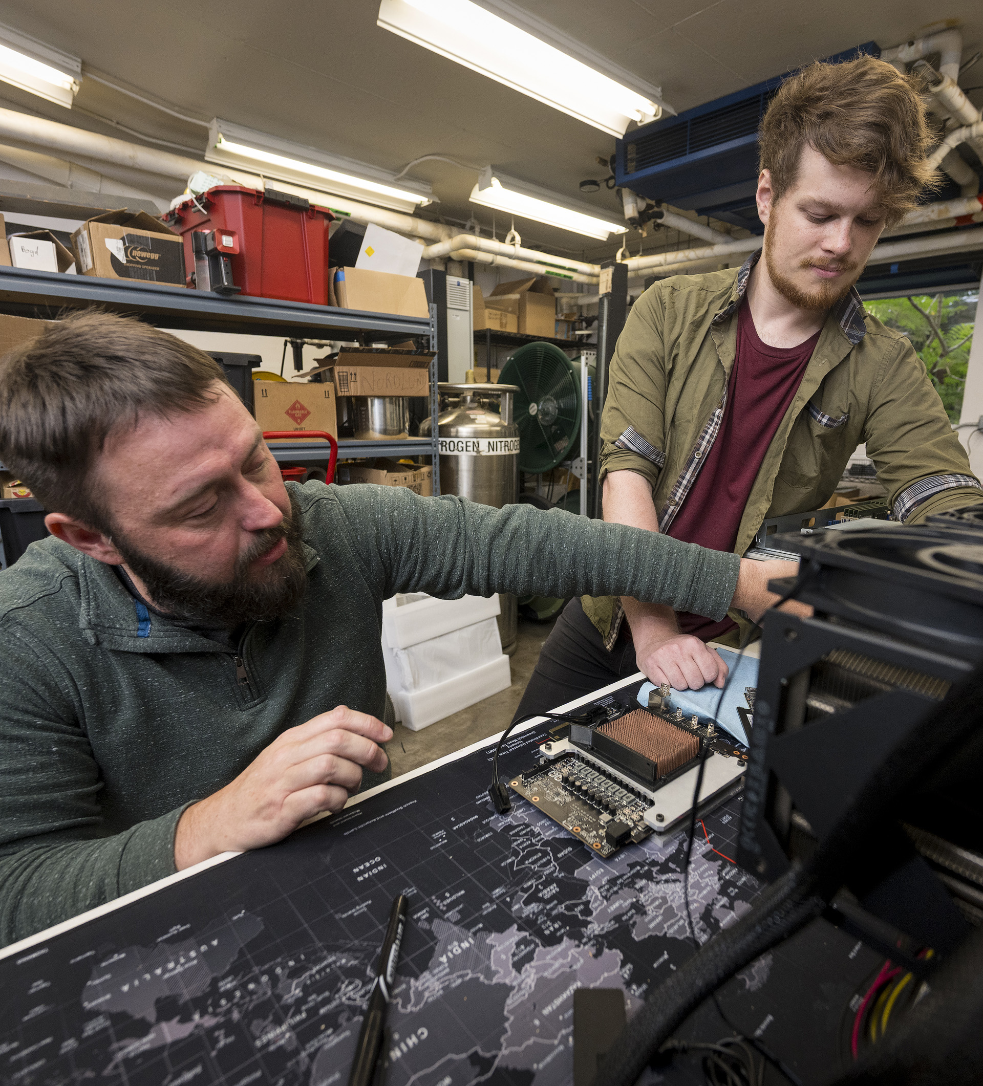 Two faculty members working on a semiconductor.
