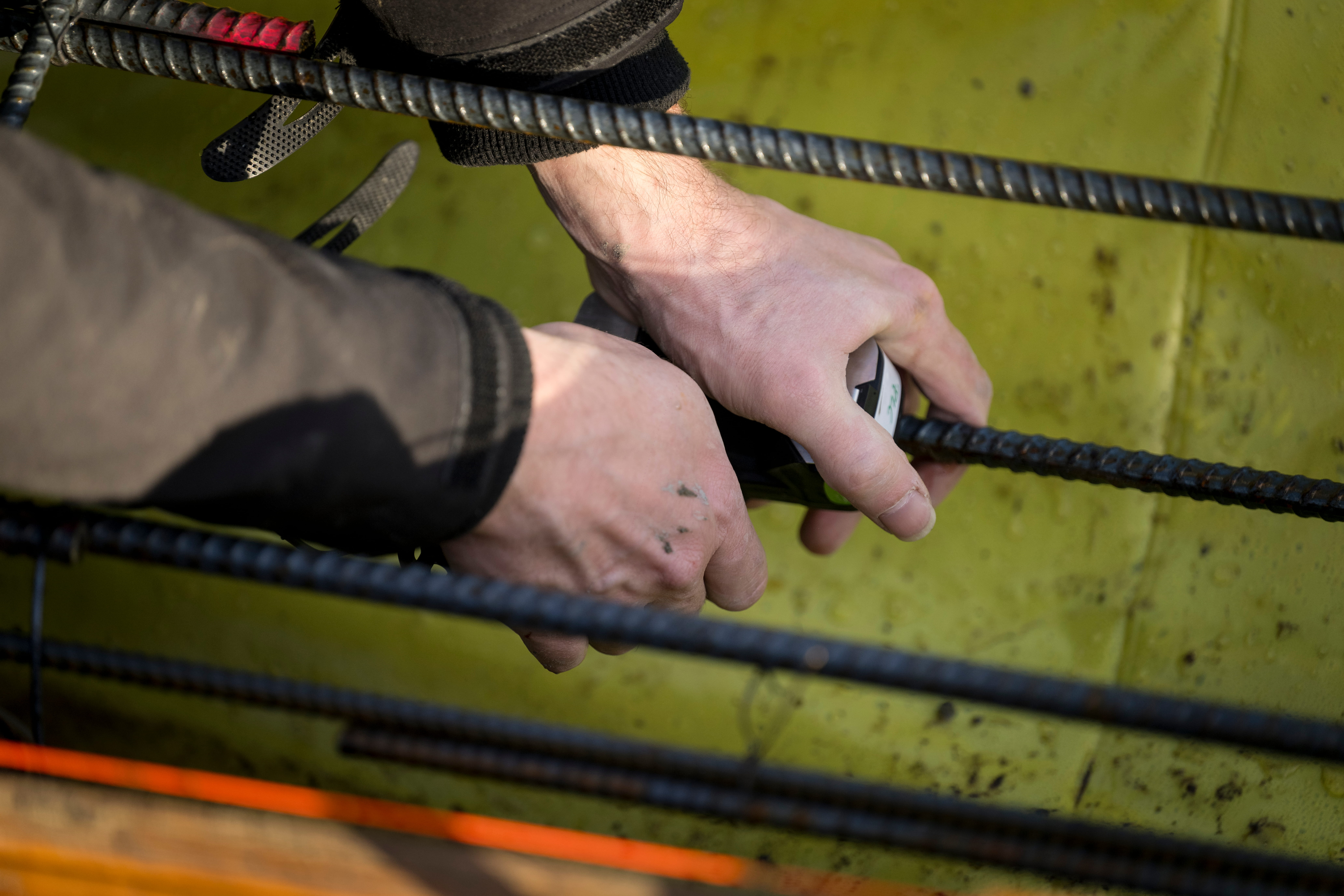 A pair of hands holding something on a rope.