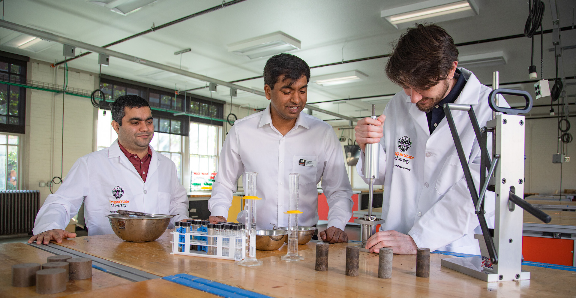 Three researchers working with a soil instrument.