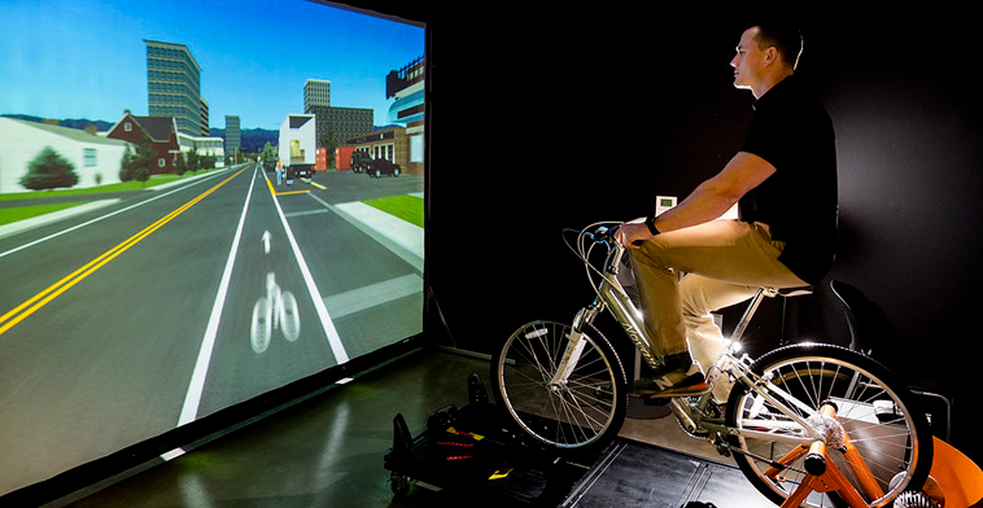 A man riding a bicycle on a simulator.