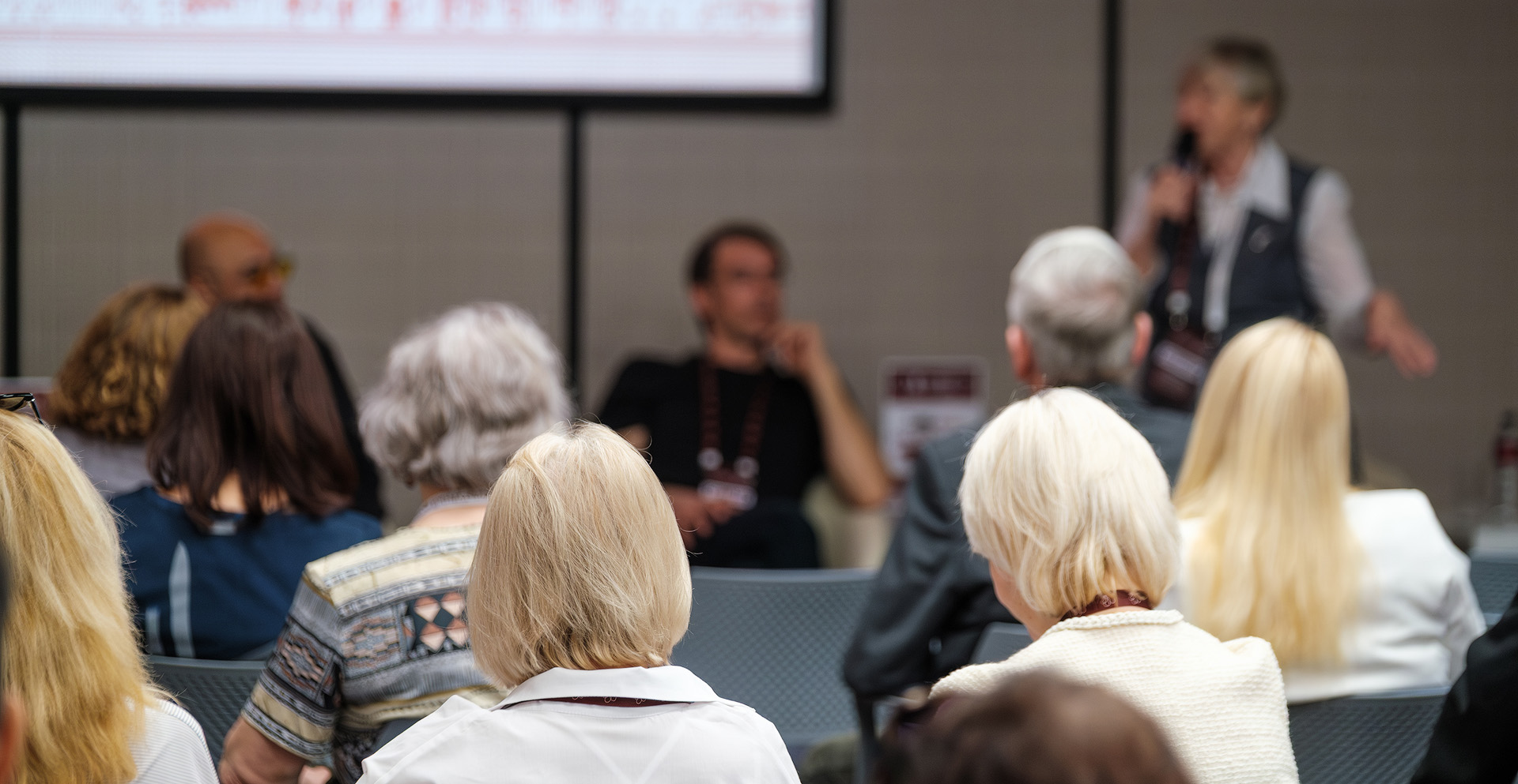 A group of people watching a man present.