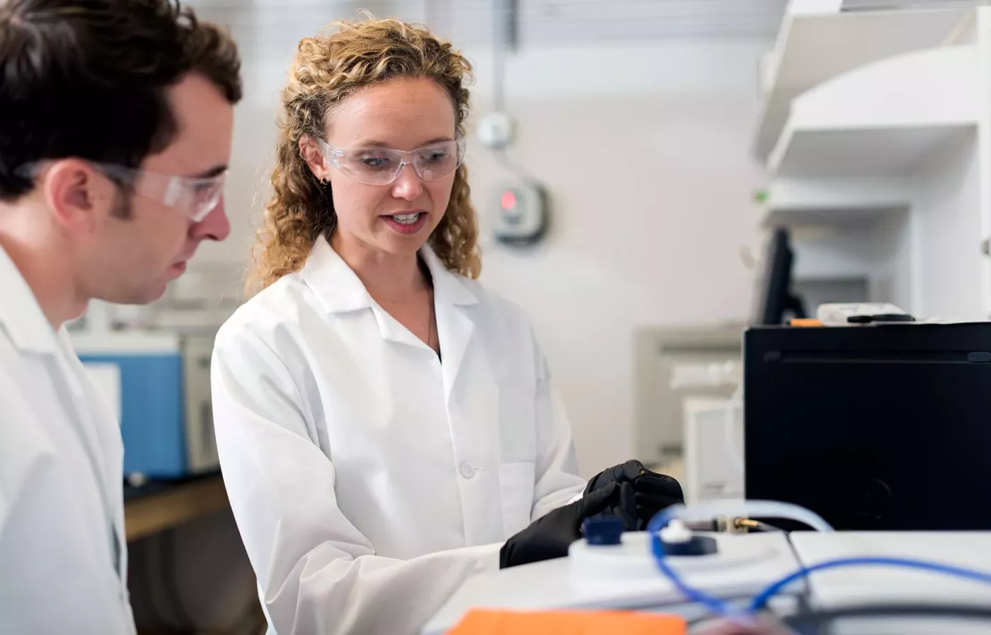 Professor Stoerzinger working with a doctoral student in her lab.