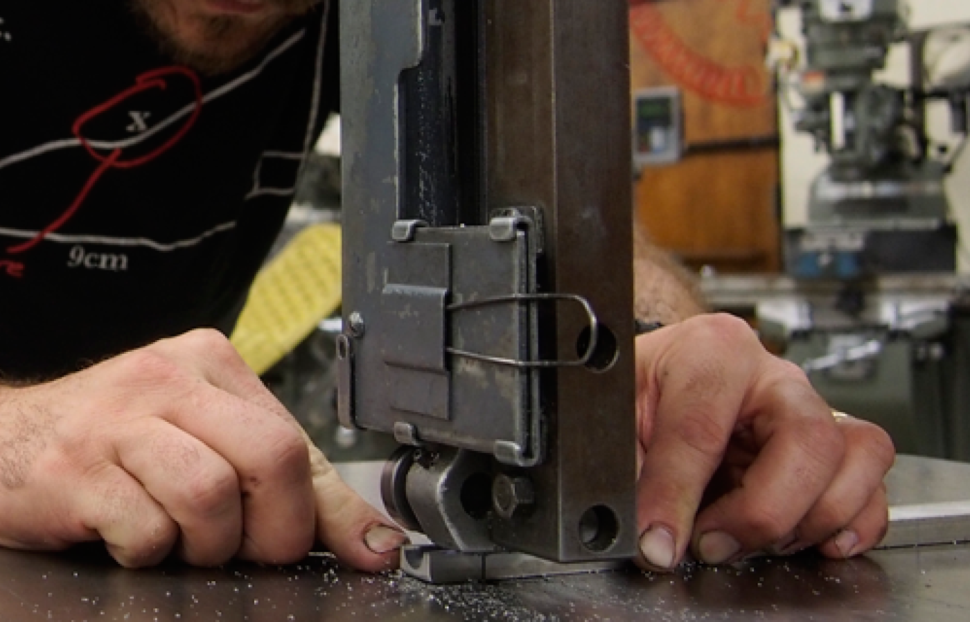 A person cutting metal. 