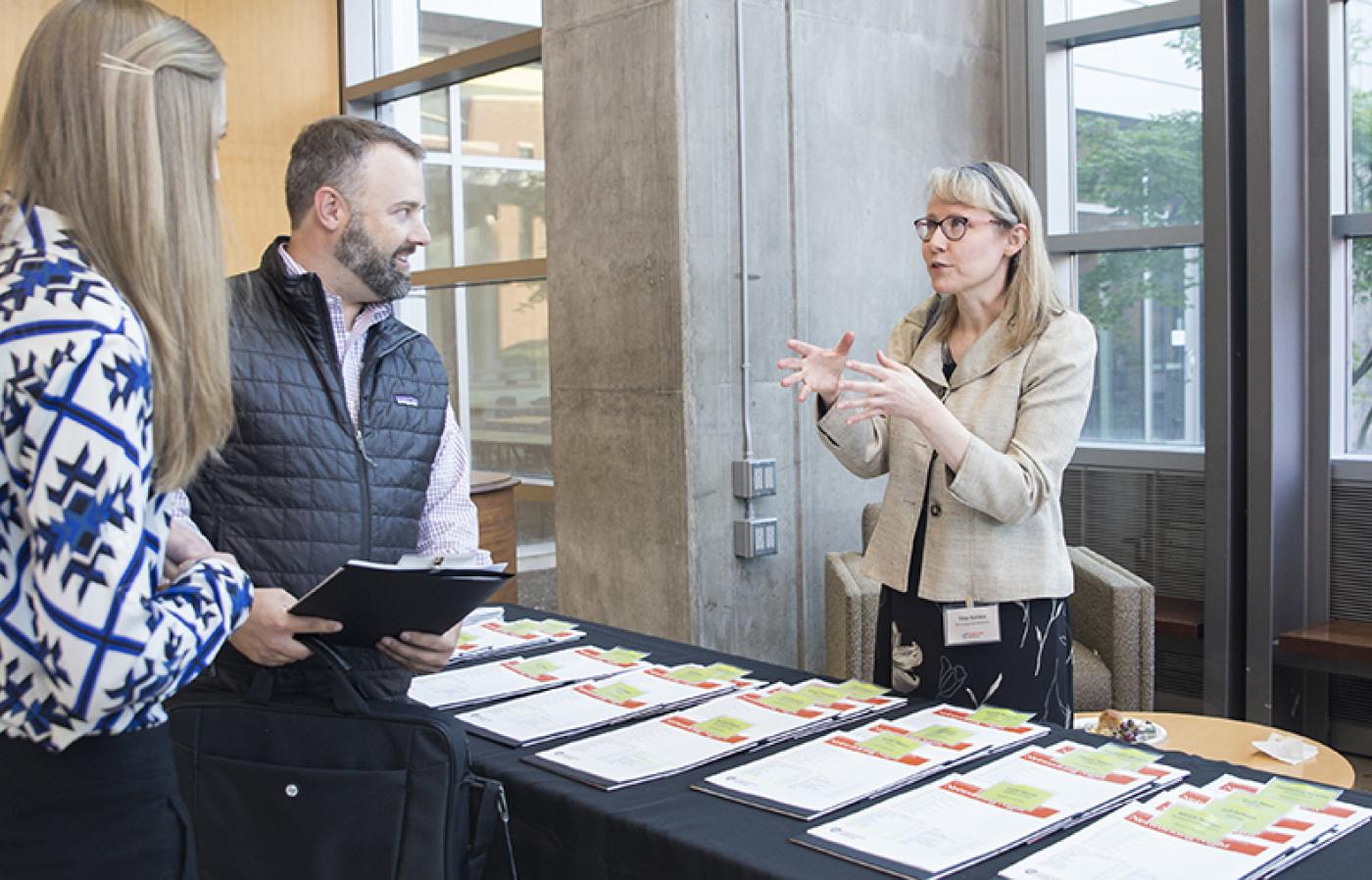 Three people having a conversation. 