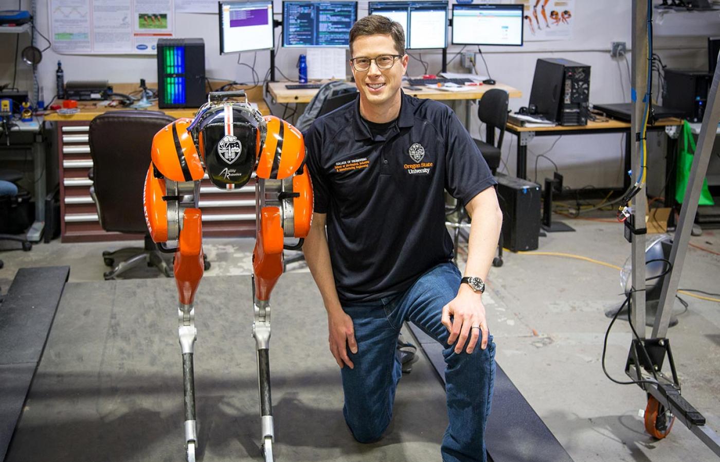 Faculty is posing with his robot.