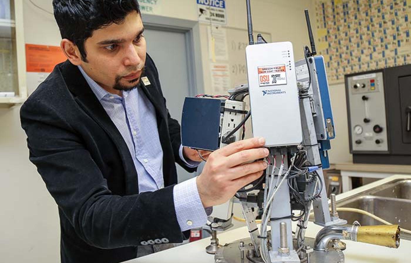 Erdem Coleri performing sensor adjustments on the Oregon Field Tack Coat Tester