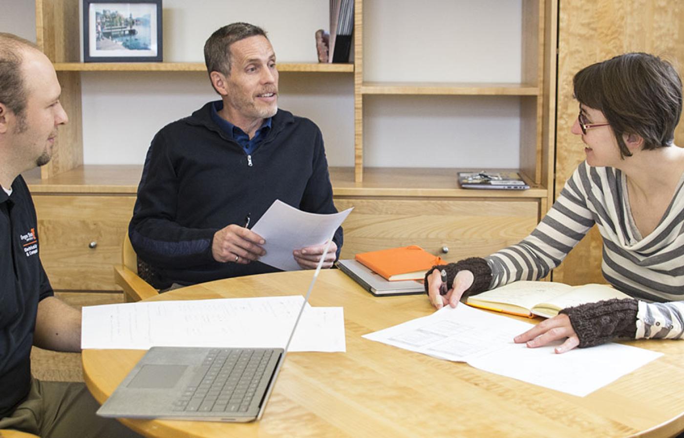 Tom Weller in a meeting with two other people.