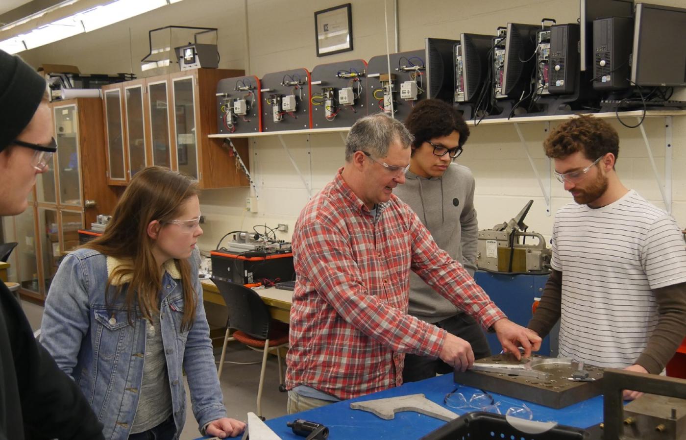 Scott Campbell, an instructor in MIME, prepares a demonstration for students in a manufacturing lab. 