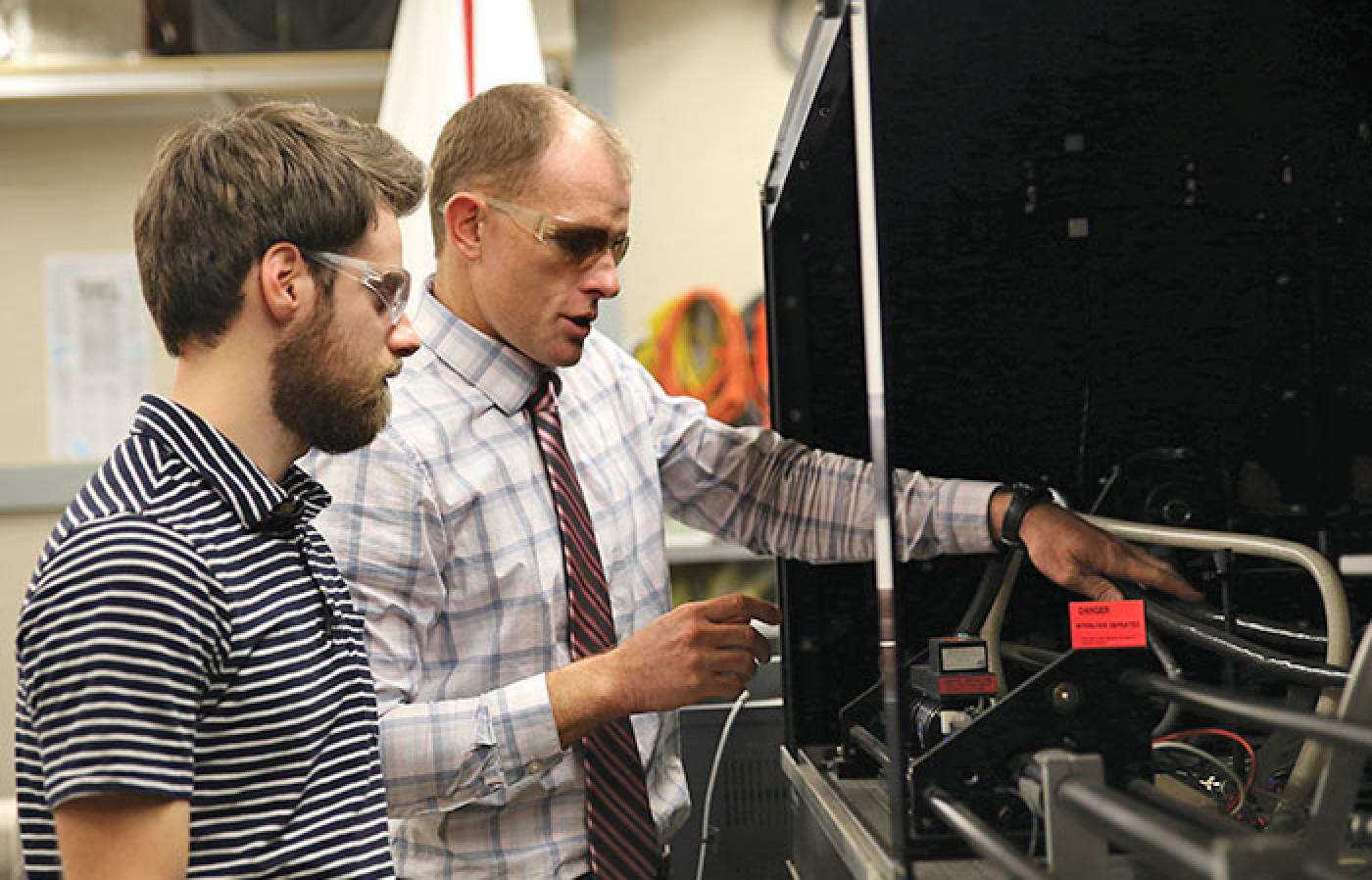 Nathan Gardner and David Blunck set up an experiment in the lab.