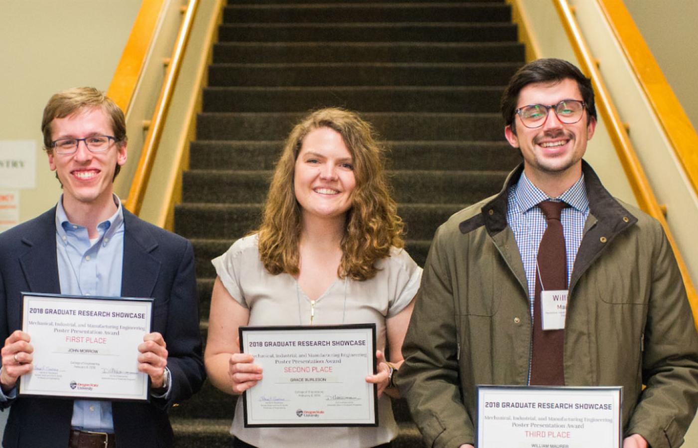 Graduate students John Morrow, Grace Burleson and William Maurer posing together for a photo with their 2018 graduate research showcase awards.