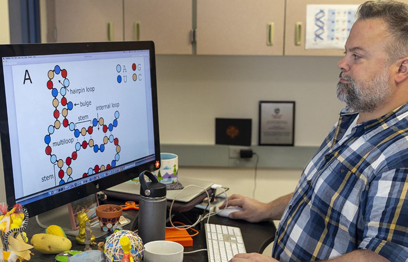 David Hendrix showing a drawing on his desktop screen.