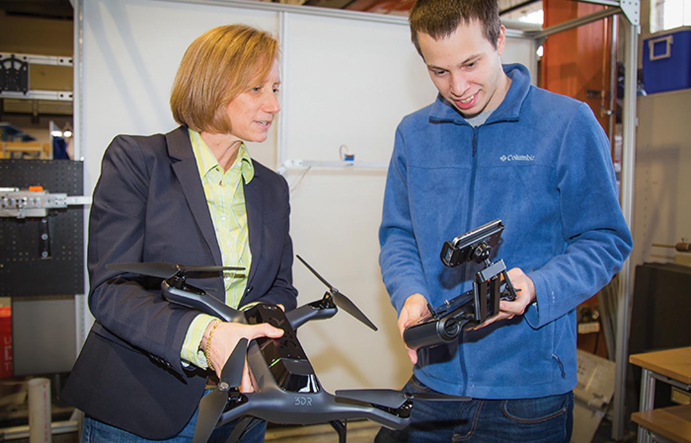 Julie A Adams and Jamison Heard use equipment during a hands-on demonstration.