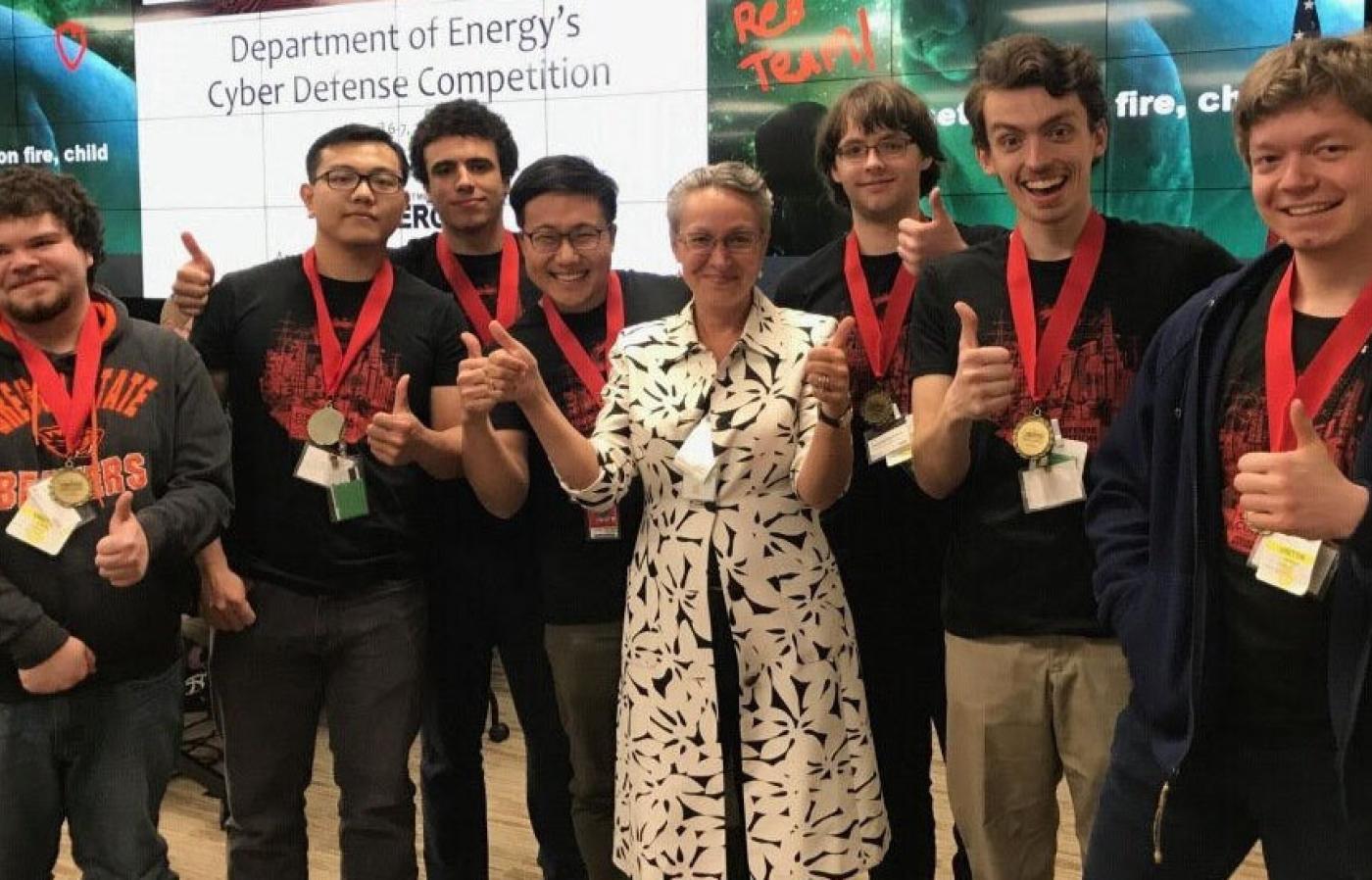 Student team standing with award necklace. 