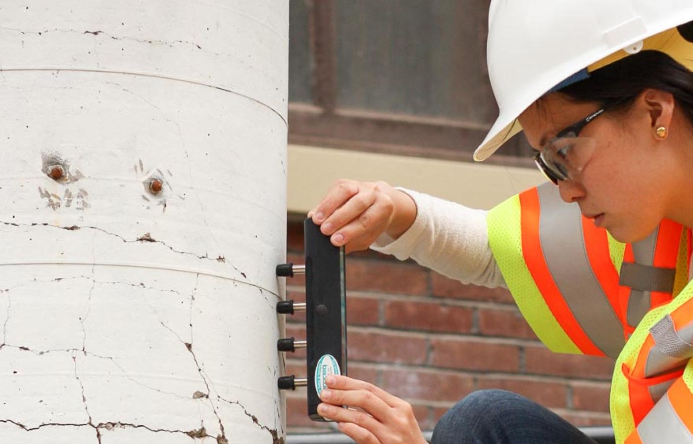 A women in a construction jacket doing work.